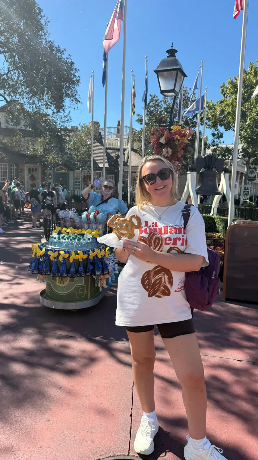 Sam at a stall in a Disney park in Florida on a bright day