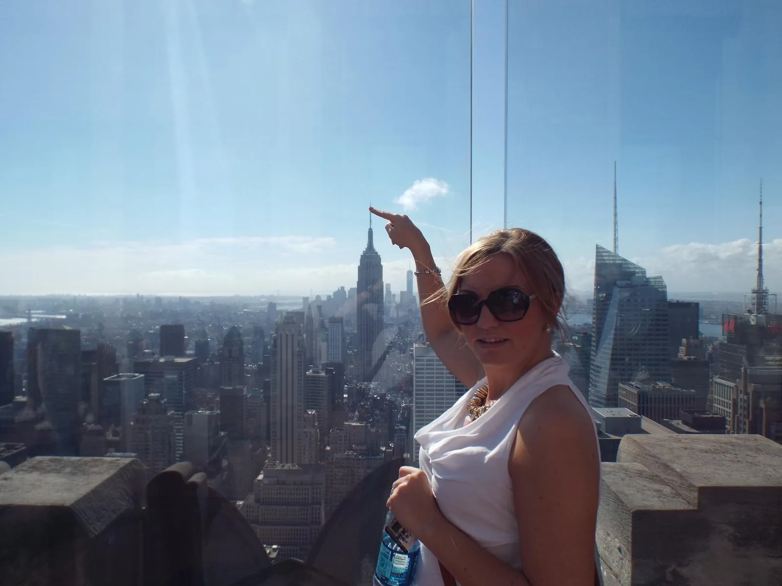 Sam pointing towards the Empire State Building from a high viewpoint in New York
